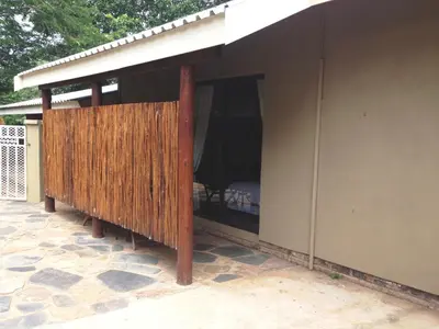 a screened in porch of a house at Gecko Cottages in Hectorspruit