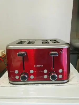 a red toaster sitting on top of a counter at Gecko Cottages in Hectorspruit