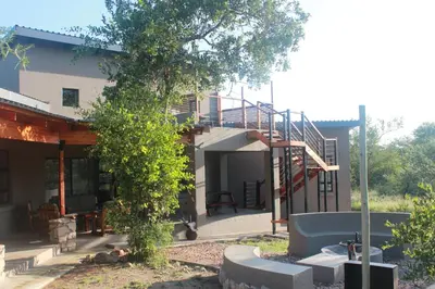a building with a staircase in front of it at Sweni Lodge 91 Mjejane Kruger Park in Hectorspruit