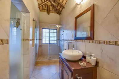 a bathroom with a sink and a shower at Kassaboera Lodge in Hartbeespoort