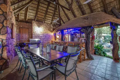a dining room with a table and chairs at Kassaboera Lodge in Hartbeespoort
