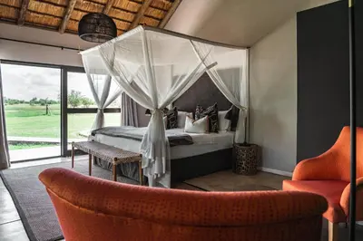 a bedroom with a bed with a canopy at Xanatseni Private Camp in Klaserie Private Nature Reserve