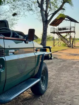 a car parked on the side of the road with a park at Xanatseni Private Camp in Klaserie Private Nature Reserve
