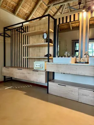 a bathroom with a sink and a mirror at Xanatseni Private Camp in Klaserie Private Nature Reserve