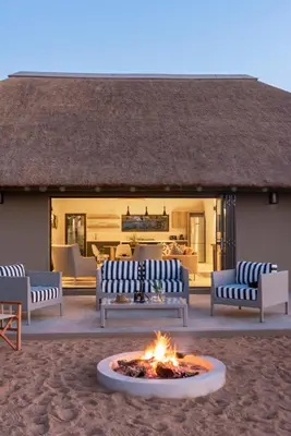 a fire pit in front of a house at Xanatseni Private Camp in Klaserie Private Nature Reserve