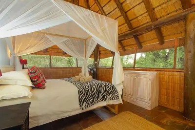 a bedroom with a bed with a canopy at Marloth Kruger Little Manor in Marloth Park