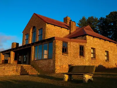 a brick building with a bench in front of it at Angel's Rest in Dullstroom