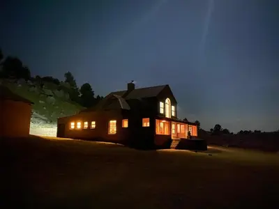 a house lit up at night with its lights on at Angel's Rest in Dullstroom