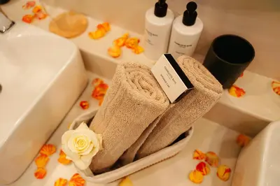 a pile of towels sitting on a bathroom counter next to a sink at Bambuu Lakeside Lodge in Hazyview