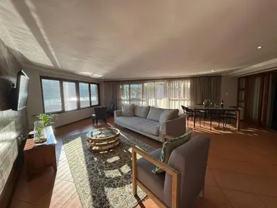 a living room with a couch and a table at Bambuu Lakeside Lodge in Hazyview