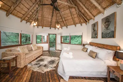a living room with a bed and a couch at Serenity Mountain and Forest Lodge in Malelane