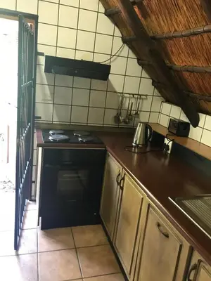 a kitchen with a sink and a stove top oven at Foundry Guest Lodge in Pretoria