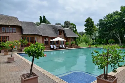 a house with a swimming pool in front of it at Owls Loft Guest House in Midrand