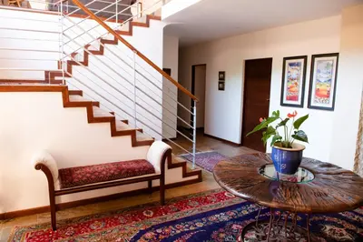 a living room with a table and a staircase at 37 on Charles in Pretoria