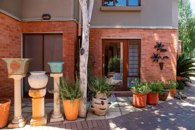 a group of potted plants in front of a house at 37 on Charles in Pretoria