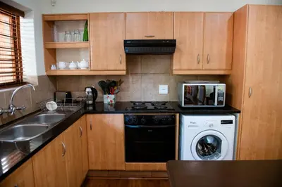 a kitchen with a stove and a dishwasher and a sink at 37 on Charles in Pretoria