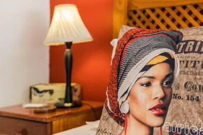 a bed with a pillow with a picture of a woman at Rozendal Guest House in Centurion