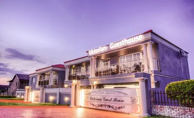 a building with a sign on the front of it at Victorian Guest House in Nelspruit