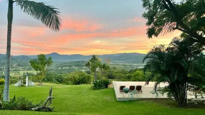 a patio with chairs and a view of the mountains at LoerieRoep Estate - Mountainview Selfcatering Accommodation Nelspruit in Nelspruit