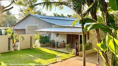 a house with a blue roof and a yard at LoerieRoep Estate - Mountainview Selfcatering Accommodation Nelspruit in Nelspruit