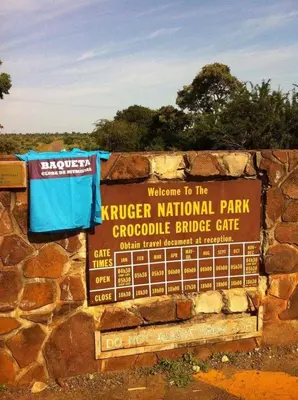 a sign for the ranger national parkrococo bridge gate at Villa-Candilabra Guesthouse in Komatipoort