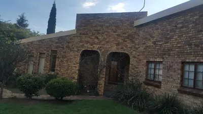 a brick building with arched windows on it at Albatross B&B in Benoni