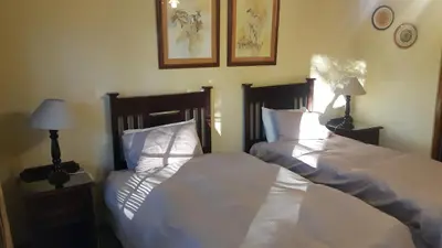 two beds sitting next to each other in a bedroom at Albatross B&B in Benoni