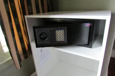 a microwave oven on top of a white shelf at Absolute Leisure Cottages in Machadodorp