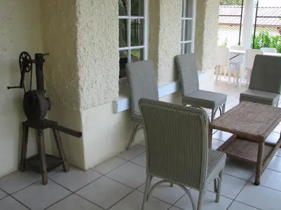 a group of chairs and a table in a room at Absolute Leisure Cottages in Machadodorp