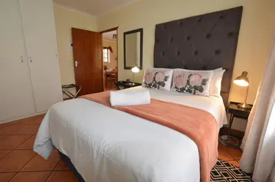 a bedroom with a large bed with a large headboard at Kairos Home in Middelburg