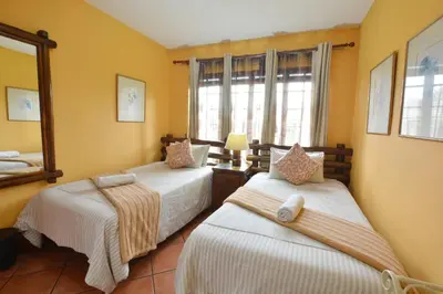 a bedroom with two beds and a mirror at Kairos Home in Middelburg