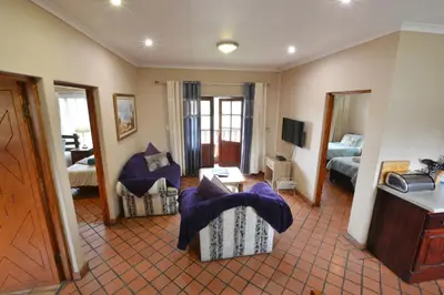 a living room with a couch and a bedroom at Kairos Home in Middelburg