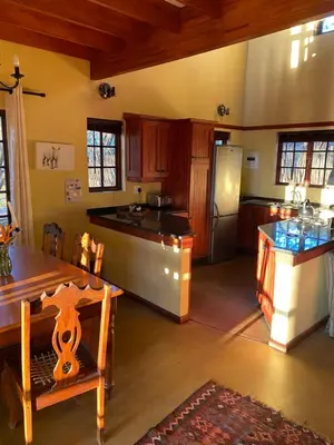 a large kitchen with a table and a refrigerator at Waterberg Cottages, Private Game Reserve in Vaalwater