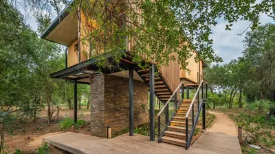 a house with a staircase leading up to it at Elephant Point in Skukuza