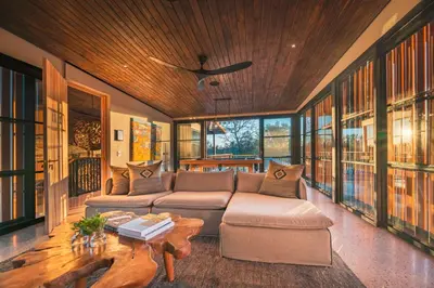 a living room with a couch and a table at Elephant Point in Skukuza