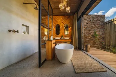 a bathroom with a tub and a sink at Elephant Point in Skukuza