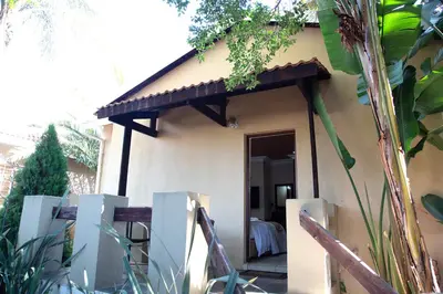 a small house with a porch with a table at Constantia Manor Guest House in Pretoria