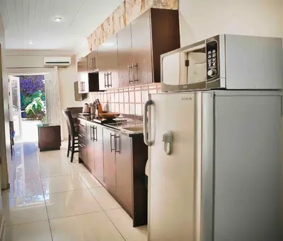 a kitchen with a stainless steel refrigerator and cabinets at Accommodation at Vans No Loadshedding in Centurion