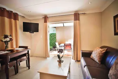 a living room with a couch and a piano at Accommodation at Vans No Loadshedding in Centurion