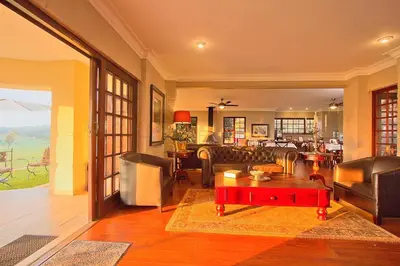 a living room with a couch and a table at Leopardsong Manor in Centurion