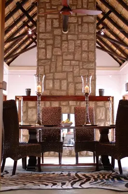 a dining room with a table and chairs at Shumbalala Game Lodge in Thornybush Game Reserve