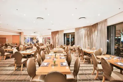 a dining room with wooden tables and chairs at RH Hotel & Apartments - Pretoria in Pretoria