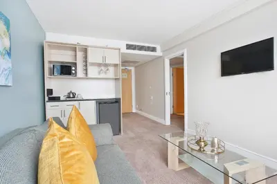a living room with a couch and a table at RH Hotel & Apartments - Pretoria in Pretoria