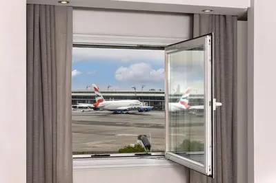 an open window with a view of an airport runway at Protea Hotel by Marriott O R Tambo Airport in Kempton Park