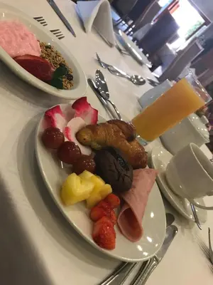a table with two plates of food on it at The Elegant Lodge Menlo Park in Pretoria