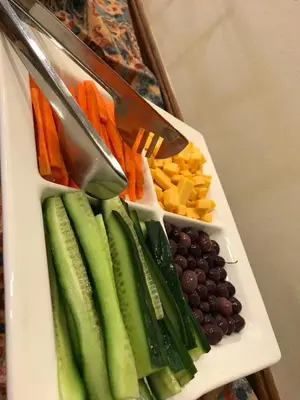 a tray with cucumbers and carrots and other vegetables at The Elegant Lodge Menlo Park in Pretoria