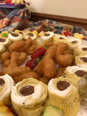 a tray of pastries and fruit on a table at The Elegant Lodge Menlo Park in Pretoria