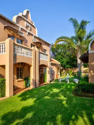 an exterior view of a house with a yard at The Elegant Lodge Menlo Park in Pretoria