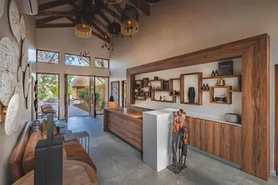 a living room with a large wooden wall at Kruger Gate Hotel in Skukuza