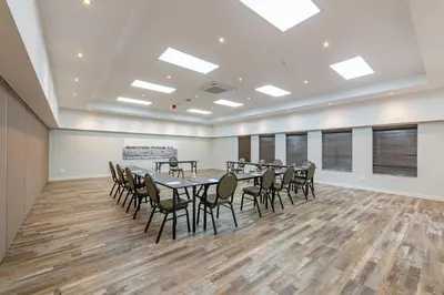 a conference room with a table and chairs at Kruger Gate Hotel in Skukuza
